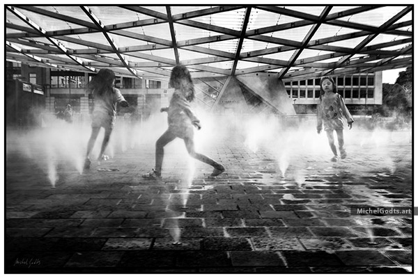 Around And Around Spray Fountains :: Black and white urban street photography - Artwork © Michel Godts