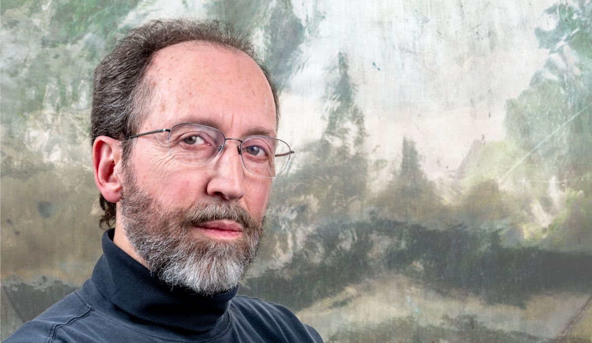 Fine art photography artist Michel Godts standing in front of one of his artwork.