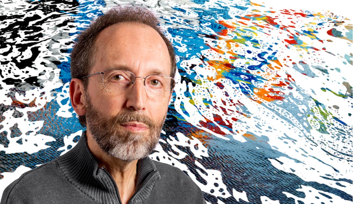 Photo artist Michel Godts standing in front of his “In Flux” artwork.